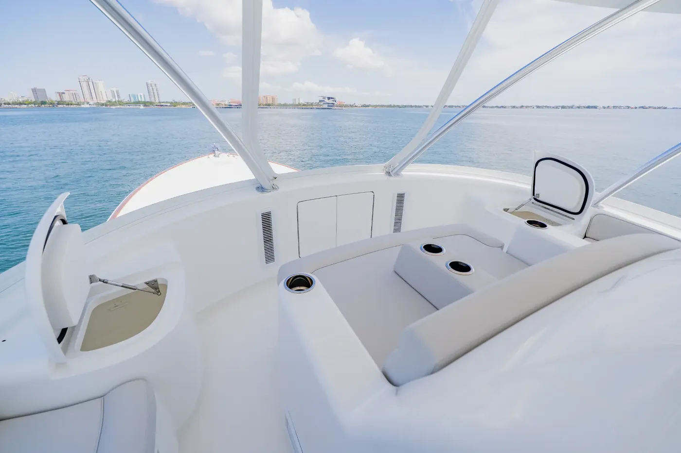 The foredeck seating aboard Mjolnir, with the bow rail and open water beyond