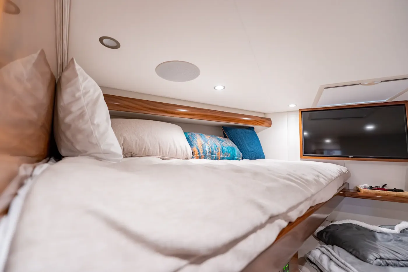 The forward cabin with twin berths and a television