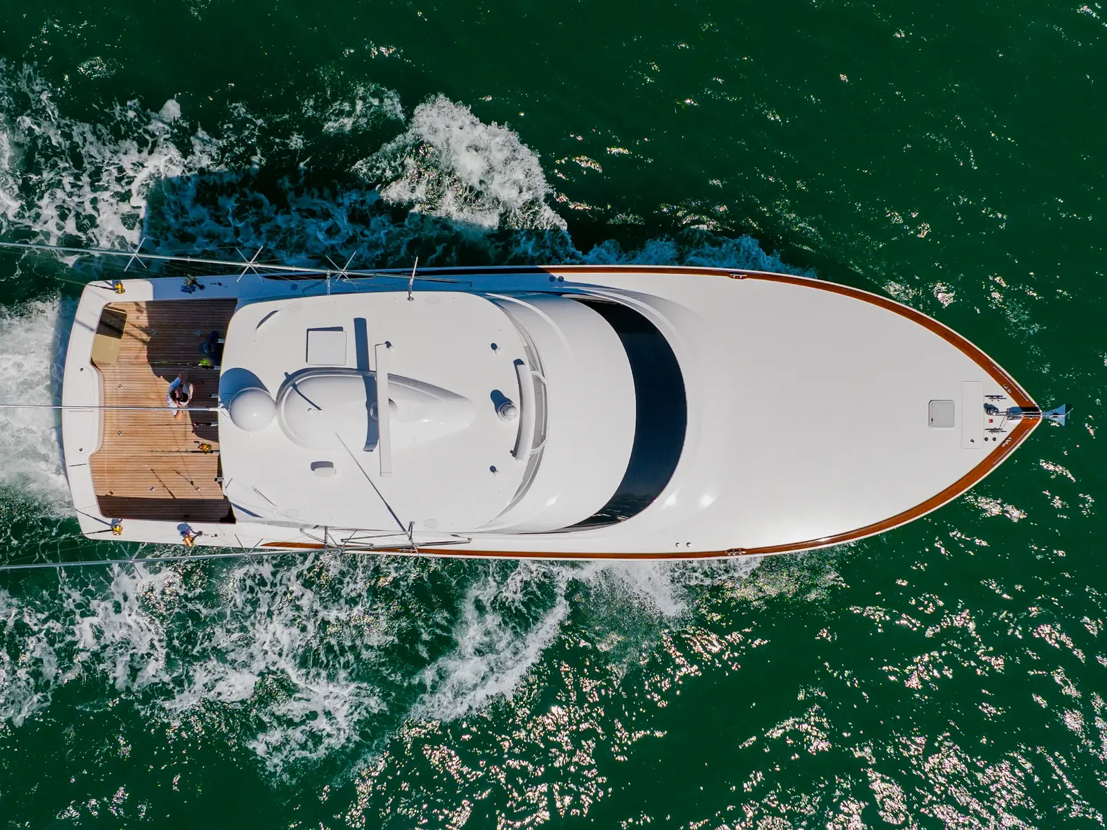 Mjolnir seen from directly above on green water, outriggers set and the wake astern