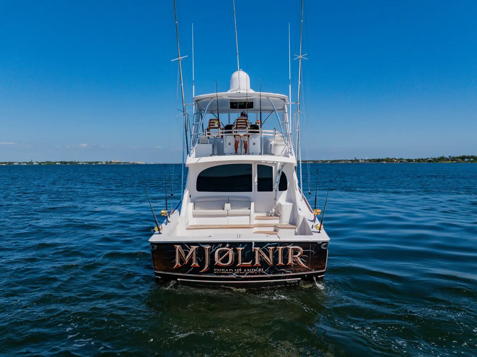 The name Mjolnir across her transom, seen from astern with the boat at rest